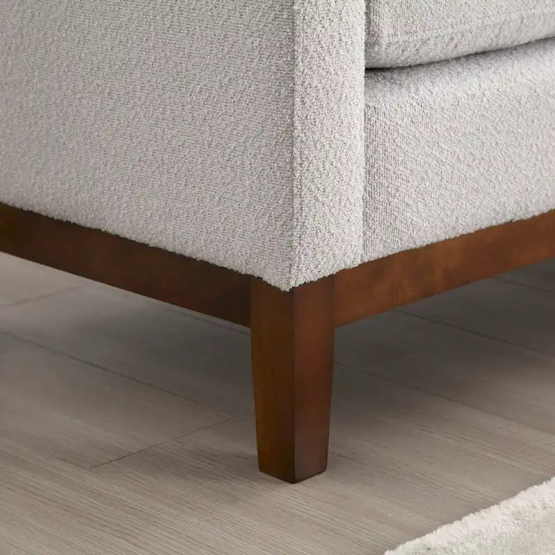 Panca imbottita con gambe in legno